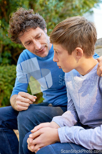 Image of Family, father in discussion with son in backyard, bonding with love and care, communication and relationship. Man with boy at home, relax in nature with talking and spending quality time outdoor