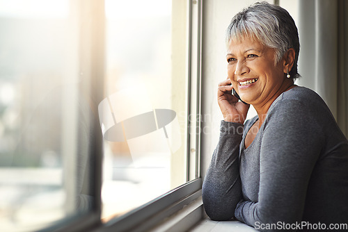 Image of Phone call, happy and senior woman talking, speaking and chat on mobile conversation, discussion or networking. Communication, window and relax elderly person talk to smartphone contact