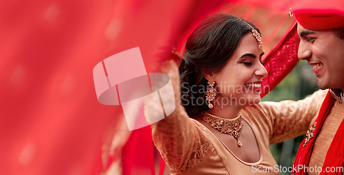 Image of Happy Indian couple, wedding and smile for love, compassion or romance together with care and joy. Hindu man and woman smiling in joyful happiness for marriage, tradition or red culture celebration