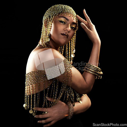 Image of African woman, portrait and gold fashion with beauty and cosmetics in a studio. Isolated, black background and young female face with crown, Egypt jewelry and culture empowerment with queen pride