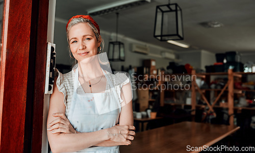 Image of Happy woman, portrait and arms crossed in small business confidence at entrance for workshop in retail store. Confident female person, ceramic designer or owner smiling for craft or creative startup