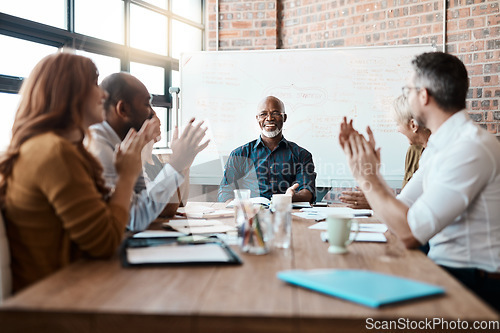 Image of Business people, meeting and applause of black man in office for congratulations, goals or target. Happy, group clapping and senior African male professional with employees in celebration of success.