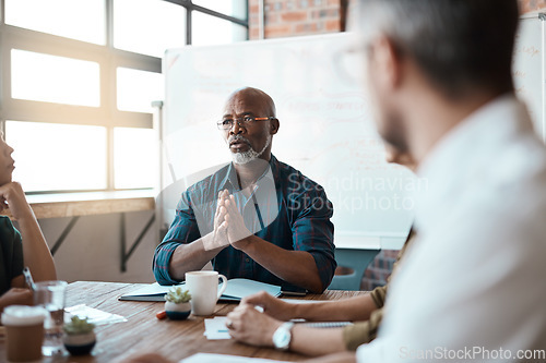 Image of Business people, meeting leader and black man in office, talking or speaking. Teamwork, ceo and serious senior African male professional brainstorming, collaboration or planning group strategy