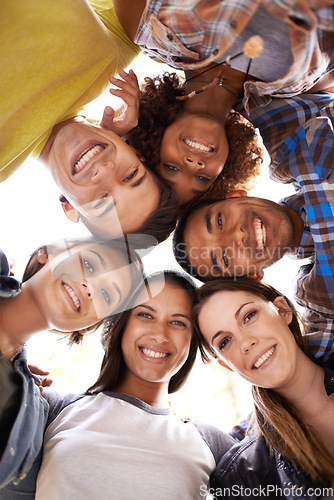 Image of Happy, portrait and low angle of friends in circle with diversity, unity and collaboration. Teamwork, smile and group of multiracial people in huddle together for solidarity, community and friendship