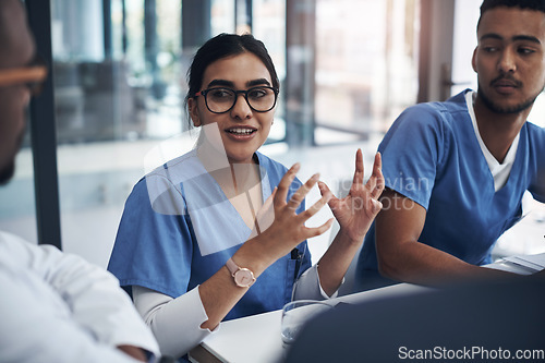 Image of Healthcare, medical team in a meeting and talking in conference room. Medicine discussion or communication, teamwork or collaboration and doctors or nurses speaking about confidential patient data