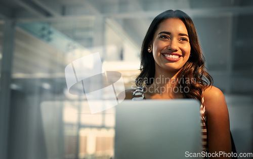 Image of Laptop, thinking and glass with a business woman in the office, working while sitting at her desk. Computer, idea or smile and a happy young female employee with a vision of the future at work
