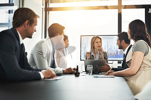 Image of Meeting, finance and statistics with a business woman giving a presentation to her team in the boardroom. Laptop, stock market or accounting with a female manager talking to a group of people at work