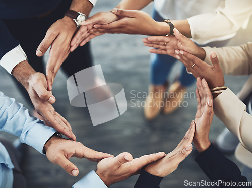 Image of Collaboration, diversity and business people with their hands together in a circle for unity. Teamwork, friends and top view of multiracial employees with connection for team building in the office.