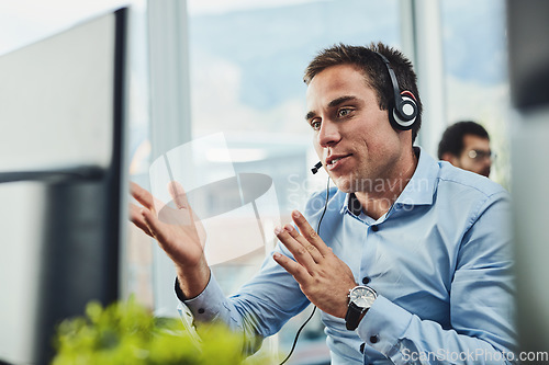 Image of Businessman, call center and consulting on computer in customer support, service or telemarketing at office. Man employee, consultant or agent talking on PC for online advice or help in contact us