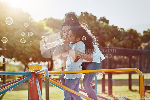 Image of Mother with daughter on roundabout at park, bubbles and playing together with fun outdoor. Love, care and bonding with family happiness, woman and girl enjoying time at playground with freedom