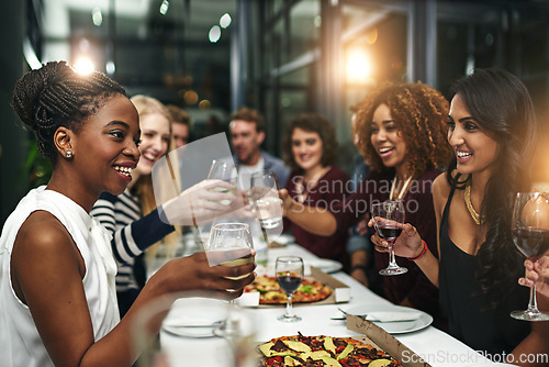 Image of Food, party and wine with friends at restaurant for celebration, pizza and social event. Happy, diversity and toast with group of people eating together for fine dining, cheers and free time