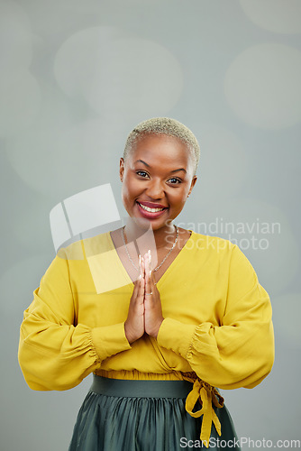 Image of Praying hands, thank you and portrait of happy woman in studio with gratitude sign on wall background. Face, together hand and smile by female person showing space, prayer and worship emoji icon