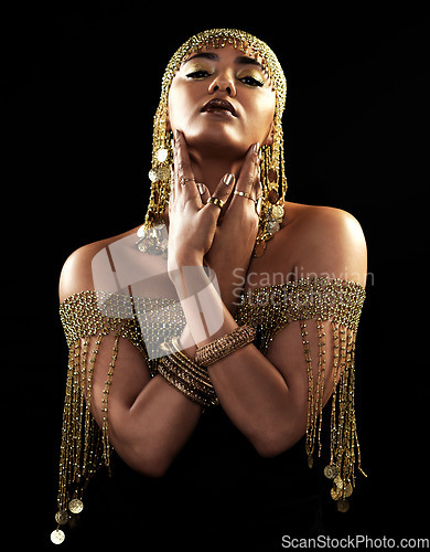 Image of African woman, portrait and gold style with beauty and cosmetics in a studio. Isolated, black background and young female face with crown, Egypt fashion and queen empowerment with luxury and makeup