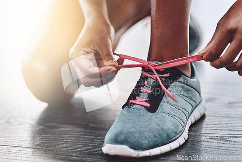 Image of Shoes, closeup and person tying laces to start exercise, workout or wellness sport in a gym for health performance. Sneakers, sports and hands of a healthy woman or runner ready for training