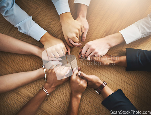 Image of Circle, solidarity and people holding hands by table at group counseling or therapy session. Gratitude, trust and friends with intimate moment for prayer together for religion, unity and connection.