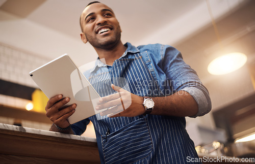 Image of Coffee shop, tablet and smile with man in cafe for online, entrepreneurship and startup. African, technology and food industry with small business owner in restaurant for barista, network and waiter