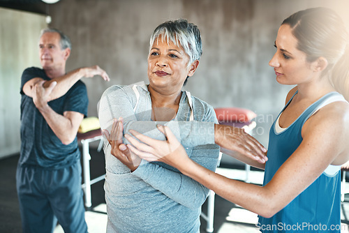 Image of Stretching, physiotherapy and old woman with personal trainer for fitness, wellness or rehabilitation. Health, workout or retirement with senior patient and female trainer in gym for warm up training