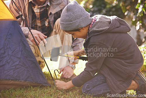 Image of Dad, kid and hammer tent for camping outdoor in nature on vacation, bonding together and summer. Father, boy and preparing camp, learning and helping in forest for travel, education and adventure.