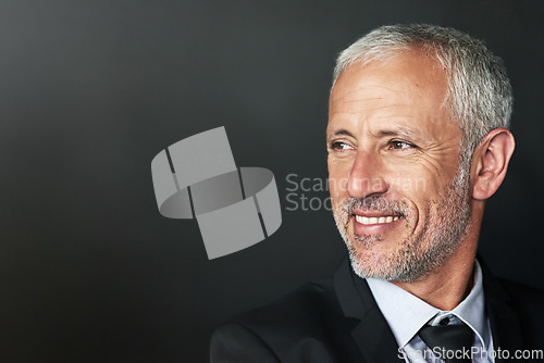 Image of Businessman, thinking and happy with a smile on face with idea and space for mockup in studio. Headshot of a senior entrepreneur person on a black background for corporate vision and career pride