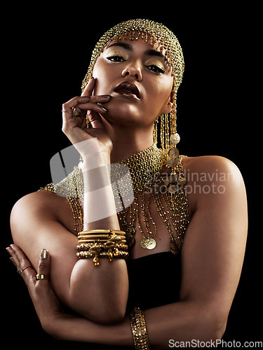 Image of Fashion, portrait and woman with attitude in studio with jewellery, gold or creative on black background. Face, queen and lady model pose in luxury accessories for cosplay, rich and royal aesthetic