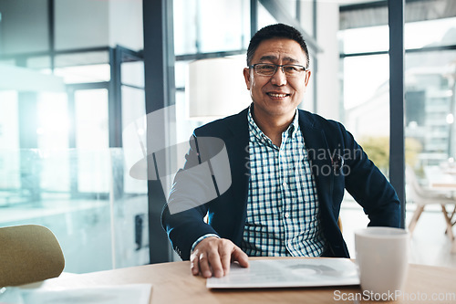 Image of Portrait, tablet and data with a business man in the office, sitting at a desk for planning or research. Happy, mindset and professional with a mature asian male manager working on his company vision