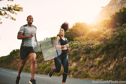 Image of Sports, health and couple running by mountain training for race, marathon or competition. Fitness, nature and African runners doing outdoor cardio workout or exercise on road trail together at sunset