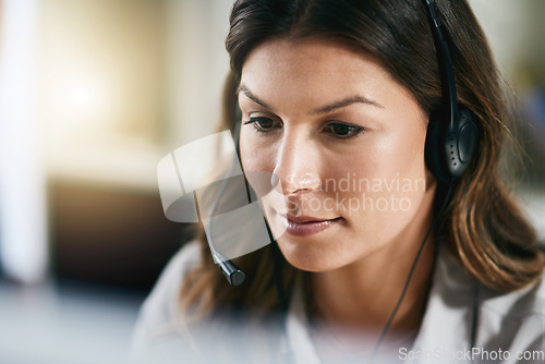 Image of Communication, face or woman in call center consulting, speaking or talking at customer services. Virtual assistant, focused or serious sales consultant in telemarketing or telecom company help desk