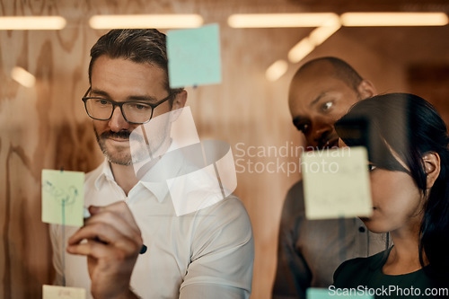Image of Businessman, writing and brainstorming in meeting for planning, schedule or team strategy at the office. Man employee in leadership or presentation for training staff on sticky note or project plan