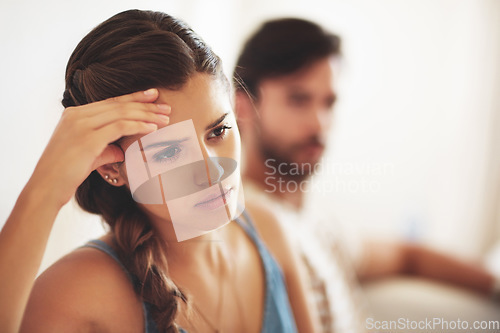 Image of Unhappy, upset or conflict with a couple arguing about an affair or breakup on their home living room sofa. Depression, abuse or domestic violence with a sad woman thinking of divorce after a fight