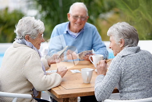 Image of Poker, smile and senior group with retirement, outdoor and cheerful together with joy, relax and playful. Elderly people, old man and mature women outside, card games and chilling with social bonding