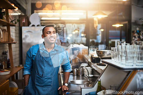 Image of Coffee shop, barista and happy black man in restaurant for service, working and thinking in cafe. Small business owner, bistro startup and male entrepreneur smile in cafeteria counter ready to serve