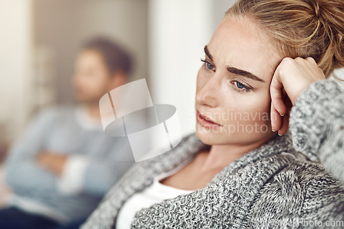 Image of Upset, depression and woman in argument with her boyfriend in the living room of their apartment. Sad, disappointed and moody female person with conflict, fight or breakup with partner at their home.