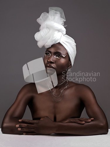 Image of Beauty, fashion and black woman with makeup, thinking and confident against a grey studio background. Female person, girl and model with ideas, fantasy and feminine with fierce attitude and culture