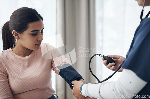 Image of Blood pressure, woman and health test with support at a clinic and healthcare hospital with doctor. Monitor, checking and nurse with young female patient at a wellness and medical consultation