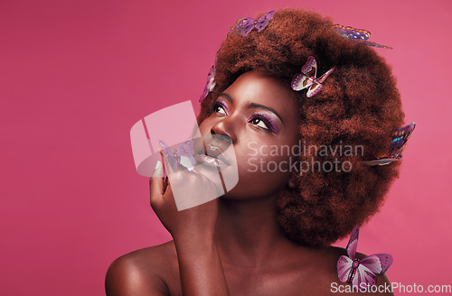 Image of Cosmetic, makeup and black woman with butterflies in a studio with beauty, natural and elegant face. Cosmetics, fantasy and young African female model posing with beautiful insects by pink background