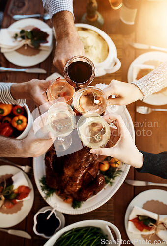 Image of Wine, food and hands of people toast to celebrate at table for holiday, Christmas or thanksgiving dinner party. Above group of family or friends with drinks for cheers while eating lunch or dinner