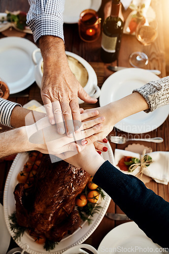 Image of Food, joining hands and people together at table to celebrate holiday, Christmas or thanksgiving. Above family or friends group with hand stack for gratitude, chicken or turkey for lunch or dinner