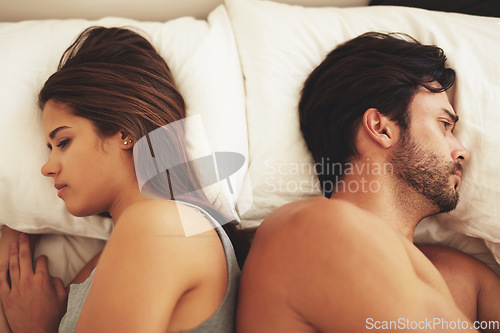 Image of Couple, bed and fight of sad people in a home with marriage conflict and problem. Divorce, fighting and above with woman and man in a bedroom in house at morning with depression for relationship