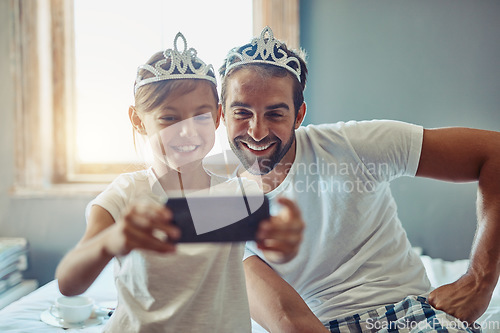 Image of Man, young girl and selfie in princess tiara, happiness with love and care at family home. Smile in picture, father and daughter bonding with crown, happy people spending time together in bedroom