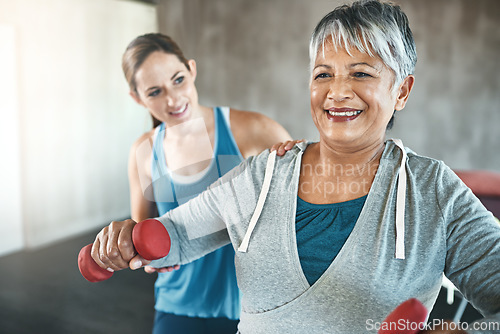 Image of Physical therapy, dumbbell and fitness with old woman and personal trainer for support, health and physiotherapy. Training, weightlifting and coaching with senior patient and female trainer for help