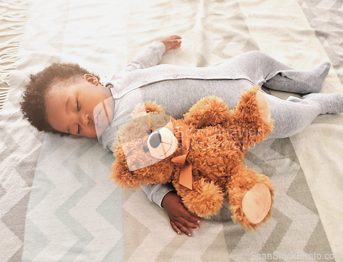 Image of Sleeping, teddy bear and nap with baby in bedroom for tired, development and innocence. Dreaming, relax and comfortable with african infant and toy at home for morning, resting and bedtime