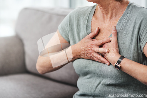 Image of Heart attack, chest pain and sick senior woman with asthma in her home living room or couch with an emergency. Crisis, medical and elderly person with discomfort due to illness or breathing problem