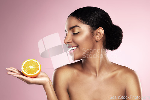 Image of Happy woman, orange fruit and beauty in studio, pink background or wellness of healthy vitamin c cosmetics. African model, citrus and nutrition for natural facial skincare, organic benefits or mockup