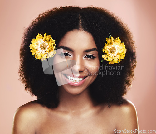 Image of Portrait of happy woman, afro and yellow flowers in studio background for beauty, floral aesthetic and shine. Face of african model, skincare and daisy plants in hair for happiness, perfume or makeup