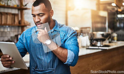Image of Focus, tablet and thinking with man in cafe for online, entrepreneurship and startup. Retail, technology and food industry with small business owner in restaurant for barista, store and coffee shop