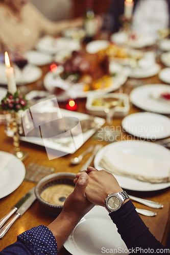 Image of Prayer, dinner and hand holding with family at table in dining room for holiday, food or praying worship. Celebration, support or gratitude with closeup of people at home for kindness, party and love