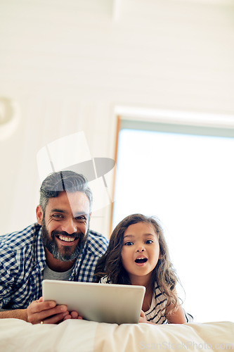 Image of Portrait, digital tablet and daughter with father on a bed for reading, story and learning in their home together. Family, face and parent and girl relax in bedroom online with ebook or subscription