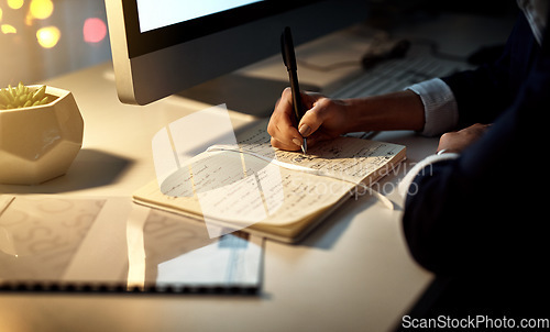 Image of Hands, writing and notebook for working at night on creative ideas, strategy or schedule at a desk. Closeup of entrepreneur woman with pen and notes for planning, information or goals for a project