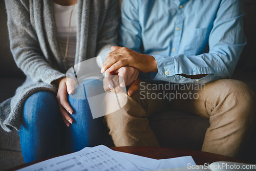 Image of Holding hands, senior couple and life insurance support with paperwork in a living room. Home, anxiety and elderly people with empathy, stress and trust with solidarity for bills and tax problem