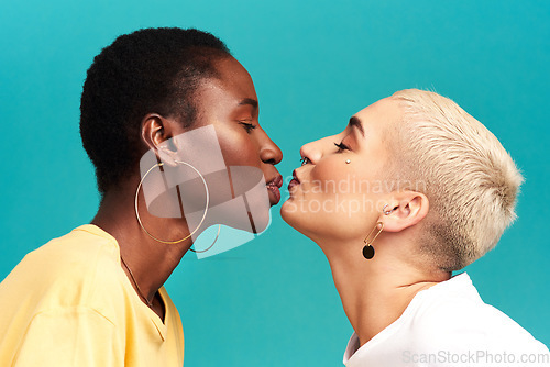 Image of Love, diversity and kiss, lesbian couple on studio background in happy lgbt relationship together. Lgbtq romance, pride and black woman kissing partner on backdrop, happiness with gen z women on date